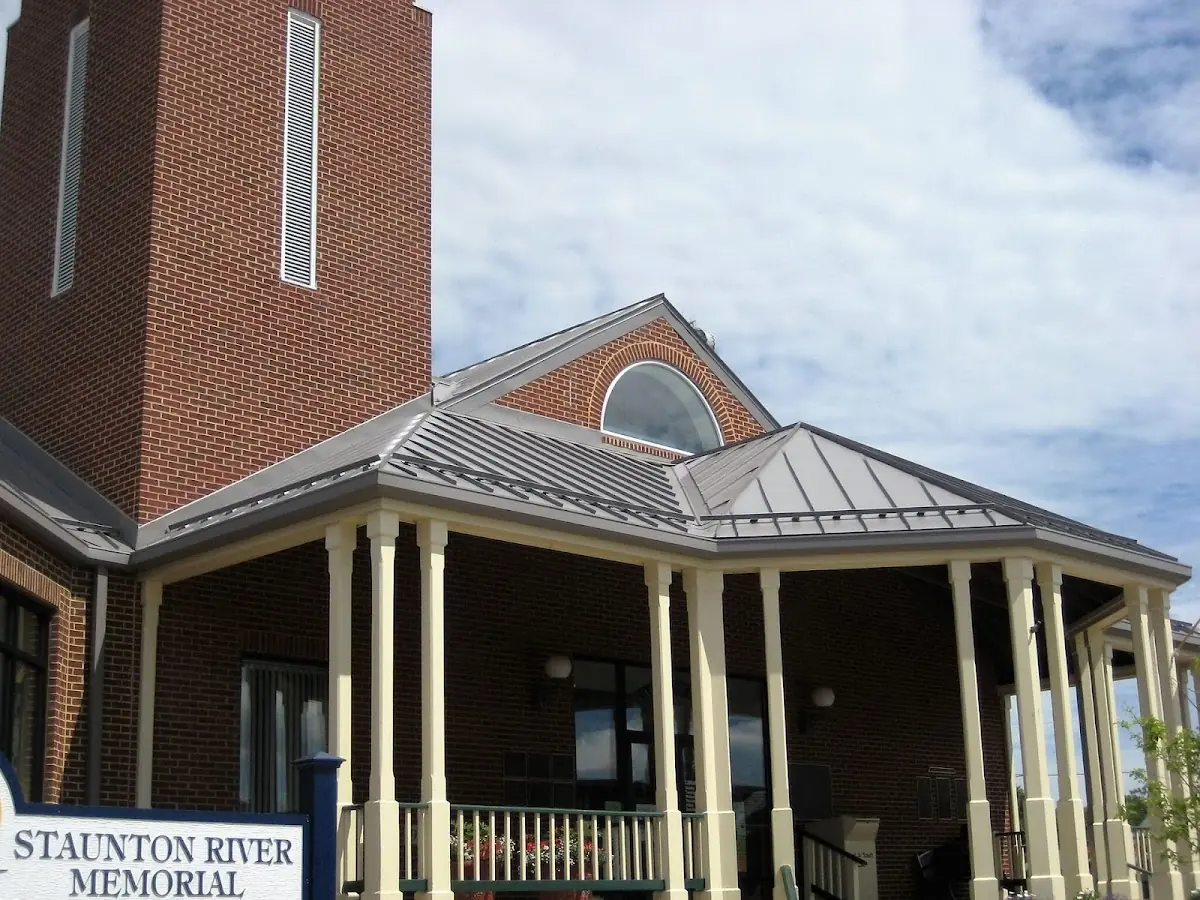 Skilled roofing craftsmen working on a residential roof in Broadalbin